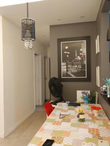 a dining room with a table with a quilt on it at APARTAMENTO COP30 - Natureza e bem estar juntos in Ananindeua
