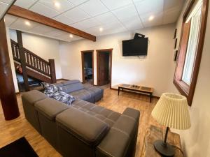 a living room with a couch and a tv at The Westview Cabin in Valemount