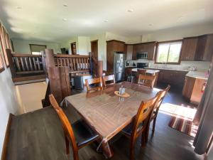 a kitchen and dining room with a table and chairs at The Westview Cabin in Valemount