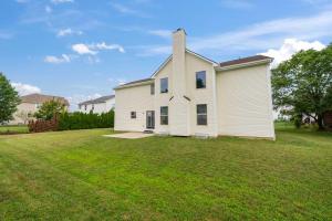 a large white house with a grass yard at Pickerington Haven - Home for 10 in Pickerington