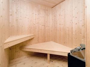 a sauna with wooden walls and wooden shelves at 8 person holiday home in Gilleleje in Udsholt Sand