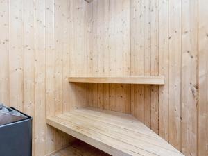 a wooden sauna with a wooden shelf in it at 6 person holiday home in Harboøre-By Traum in Harboør
