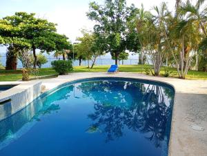 a swimming pool with a view of the water at Casa Horizonte in Puerto Escondido