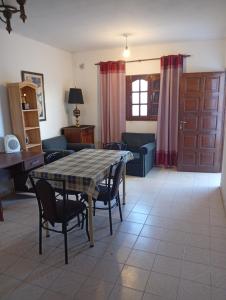 a living room with a table and chairs and a couch at Alojamiento Valle del Sol in San Fernando del Valle de Catamarca