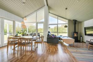 a living room with a table and a person sitting on a couch at C11330-Tarm-Blabaervej-14 in Tarm