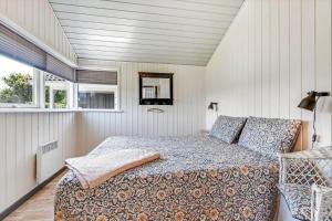 a bedroom with a bed and two windows at C11330-Tarm-Blabaervej-14 in Tarm