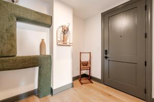 a living room with a door and a wooden floor at Elegant Scandinavian Escape Birmingham in Birmingham