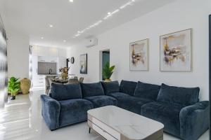 a living room with a blue couch and a table at Rocky 35 in Grand-Baie