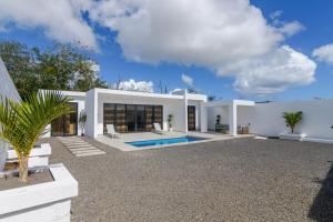 a villa with a swimming pool in a yard at Rocky 35 in Grand-Baie