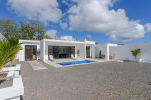 a large white house with a swimming pool at Rocky 35 in Grand-Baie