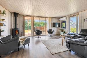 a living room with a couch and a fireplace at C11324-Tarm-Blabaervej-6 in Tarm