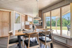 a kitchen with a large wooden table and chairs at C11324-Tarm-Blabaervej-6 in Tarm