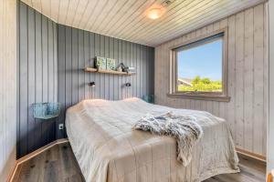 a bedroom with a bed in a room with a window at C11324-Tarm-Blabaervej-6 in Tarm