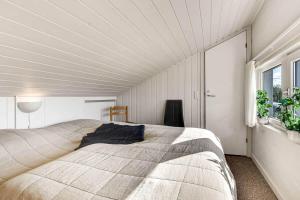 a bedroom with a large bed with a white ceiling at C11699-Hemmet-Vester-Faelled-70-A5 in Hemmet