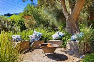 a fire pit in the middle of a garden at Bayside Retreat - Cosy Fire Beach Games Room in McCrae