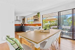 a kitchen and dining room with a table and chairs at Bayside Retreat - Cosy Fire Beach Games Room in McCrae +22 photos