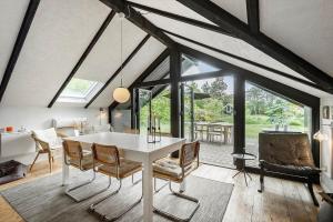 a dining room with a white table and chairs at C11409-Skjern-Syrenvej-74 in Skjern