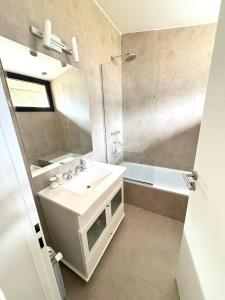 a bathroom with a sink and a shower and a mirror at Cantera Tempo 2 in Esquel +22 photos