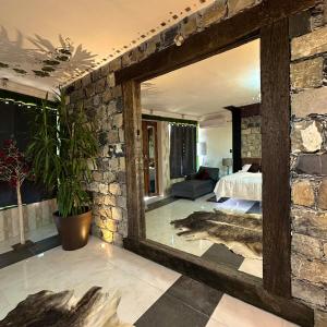 a room with a stone wall and a bedroom at Casa Catorce Loft in Parras de la Fuente