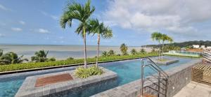 a swimming pool with a view of the beach at Unity 415 in João Pessoa