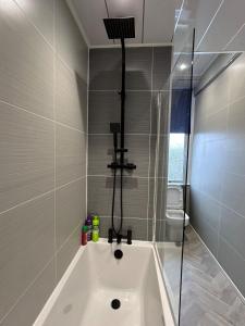 a bathroom with a shower and a bath tub at Sugar boat view in Greenock +28 photos
