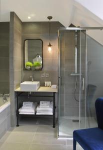 a bathroom with a sink and a shower at Le Général d'Elbée Hotel & Spa - Teritoria in Noirmoutier-en-l'lle