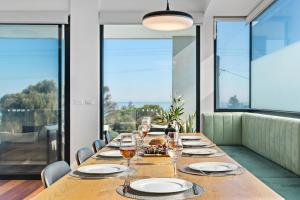 a long wooden table with wine glasses on it at Beachfront Luxury - Panoramic Views Games Wineries in Safety Beach