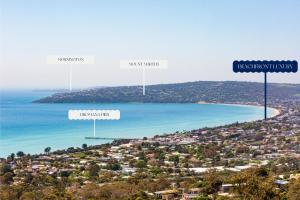 a view of a beach with two street signs at Beachfront Luxury - Panoramic Views Games Wineries in Safety Beach