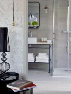a bathroom with a sink and a shower at Le Général d'Elbée Hotel & Spa - Teritoria in Noirmoutier-en-l'lle