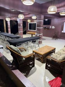 a room with a ping pong table and chairs at Riverside Lodge Bansang in Bansang