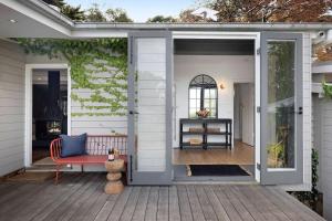 an open patio door with a red bench on a deck at Hillside Cottage - Wineries Pool in Red Hill South