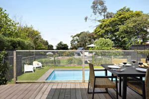 a patio with a table and chairs and a swimming pool at Hillside Cottage - Wineries Pool in Red Hill South +23 photos