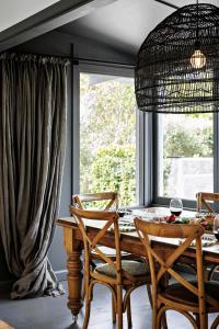 a dining room with a table and chairs and a window at Hillside Cottage - Wineries Pool in Red Hill South