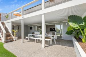 a modern house with a patio with a dining table at Luxe Oceanview - Bay Views Beach & Wineries in Dromana +32 photos