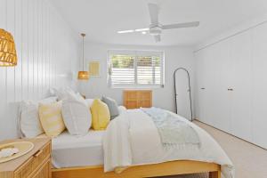 a white bedroom with a bed and a window at Luxe Oceanview - Bay Views Beach & Wineries in Dromana