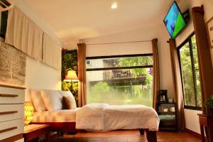 Postel nebo postele na pokoji v ubytování Apartamento Quepos, Manuel Antonio, Costa Rica