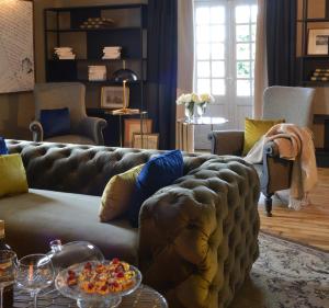 a living room with a couch and a table at Le Général d'Elbée Hotel & Spa - Teritoria in Noirmoutier-en-l'lle