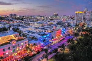 a city lit up at night with colorful lights at Luxury Villa Serena Heated Pool 15 min to Beach in Miami