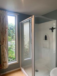 a shower in a bathroom with a window at Cottonwood in Masterton +35 photos