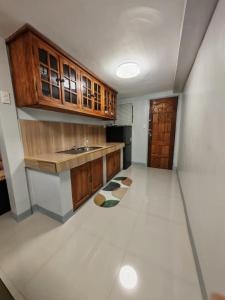 a kitchen with a sink and wooden cabinets at Grace Abode Haven in General Santos