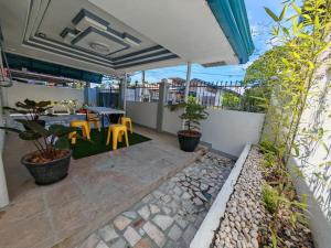 a patio with a table and chairs on a balcony at Grace Abode Haven in General Santos