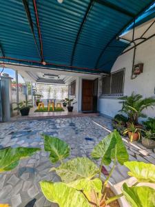 a patio with plants and a blue ceiling at Grace Abode Haven in General Santos +6 photos