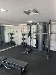 a room with a gym with several machines at Suite vista mar marinas cabo branco in João Pessoa
