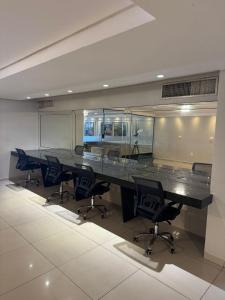 a conference room with a long table and chairs at Suite vista mar marinas cabo branco in João Pessoa