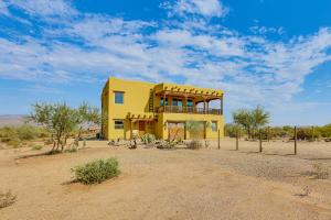a yellow house in the middle of the desert at The Hideaway - Santa Fe-Style Home in Rio Verde! in Rio Verde