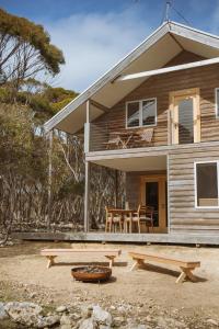 a house with a table and benches in front of it at Sea Loft Kangaroo Island in Kingscote