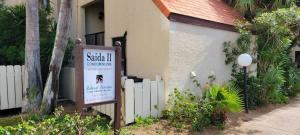 a sign in front of a building with a fence at Saida Towers II #506 condo in South Padre Island