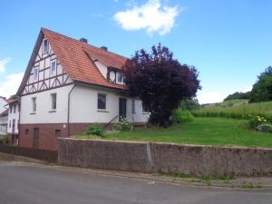 Obergude的住宿－Ferienhaus van Wijk，白色房子,有红色屋顶