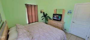 a bedroom with a bed and a television on a dresser at Los Cabos I #5 condo in South Padre Island