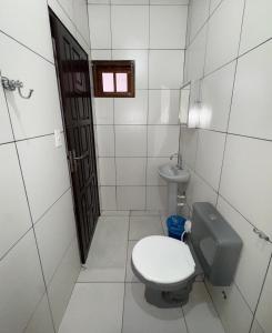 a bathroom with a toilet and a sink at Pousada JK in Pirenópolis +18 photos
